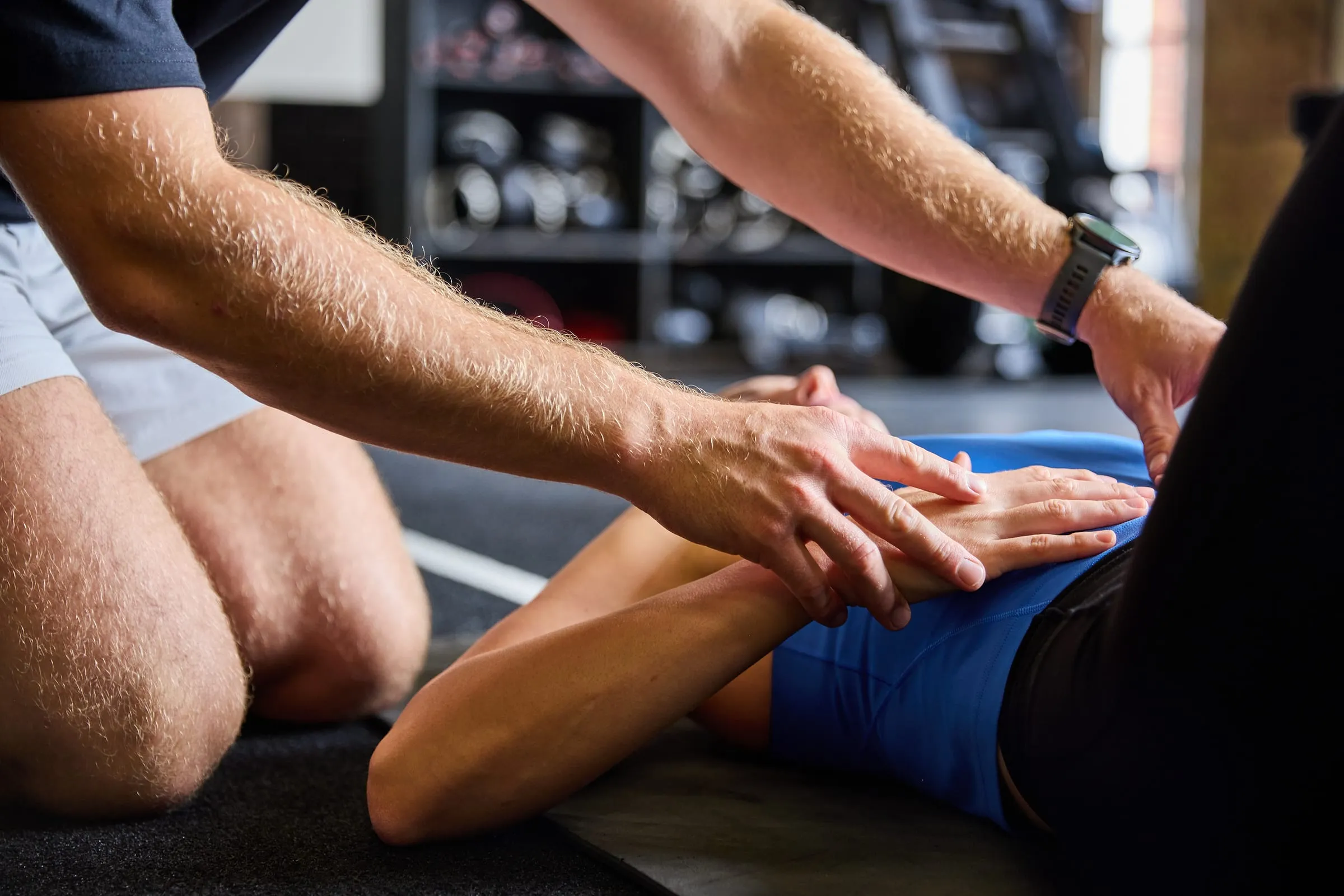 Close view of Felix's hands working on a client's leg